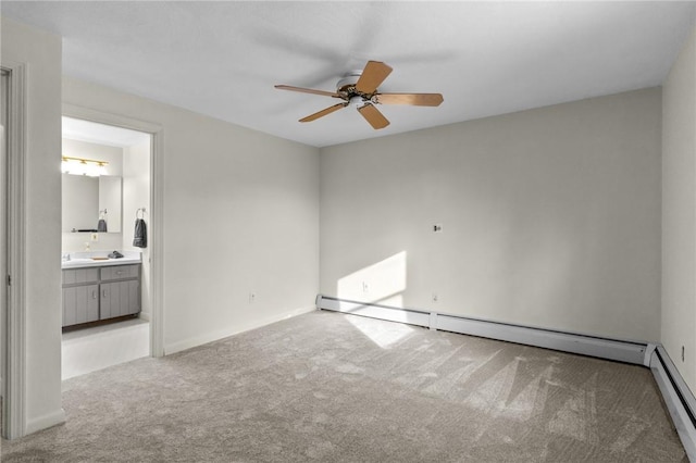 carpeted spare room featuring ceiling fan and a baseboard radiator