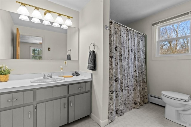 bathroom featuring vanity, a baseboard radiator, toilet, and plenty of natural light