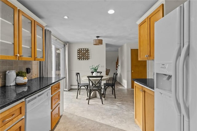 kitchen featuring white appliances, dark stone counters, and decorative backsplash