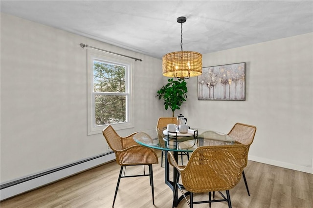 dining room featuring a baseboard radiator and light hardwood / wood-style floors