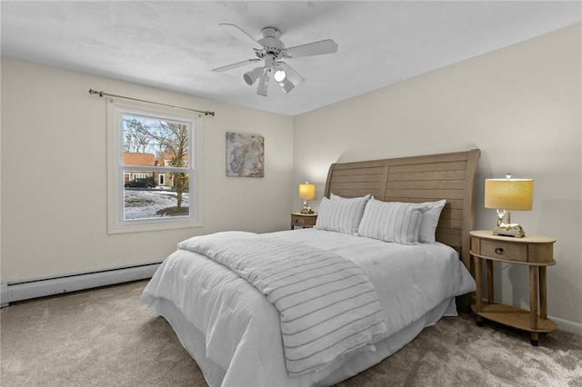 carpeted bedroom featuring a baseboard heating unit and ceiling fan