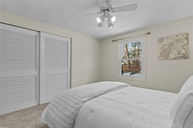 bedroom featuring light carpet, a closet, and ceiling fan