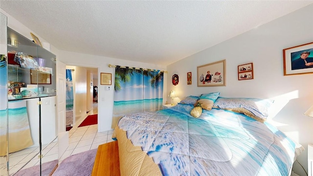 tiled bedroom featuring a textured ceiling