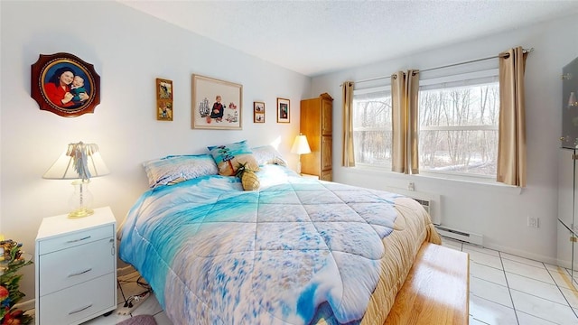 bedroom featuring baseboard heating, an AC wall unit, a textured ceiling, and light tile patterned floors