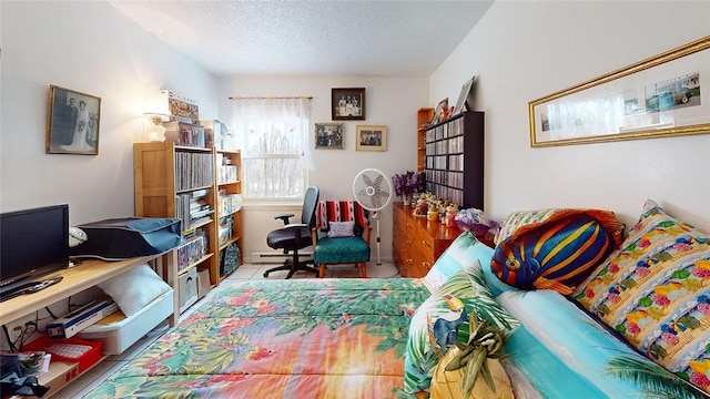 tiled bedroom with a baseboard radiator and a textured ceiling