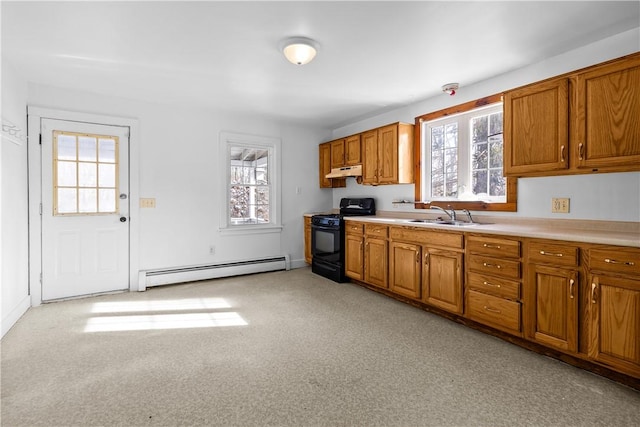 kitchen featuring baseboard heating, a healthy amount of sunlight, sink, and gas stove