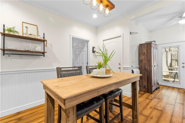 dining space featuring crown molding, ceiling fan, and light wood-type flooring