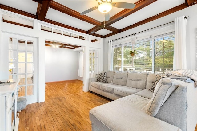 living room with ceiling fan, coffered ceiling, beam ceiling, and light wood-type flooring