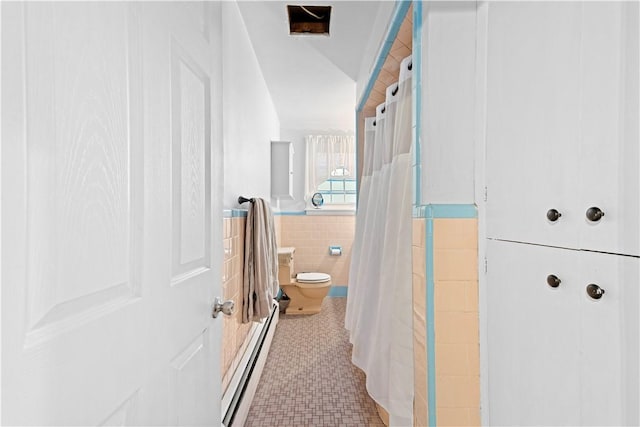 bathroom featuring tile patterned floors, toilet, tile walls, a baseboard radiator, and a shower with shower curtain