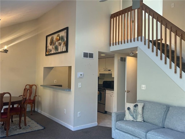 living room with a towering ceiling