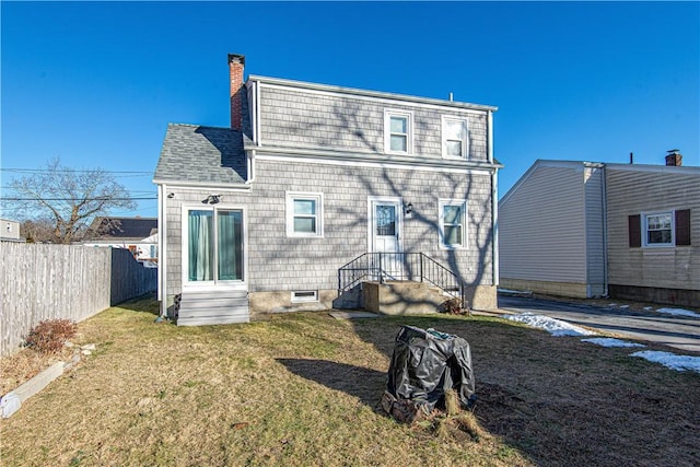 rear view of property featuring a yard