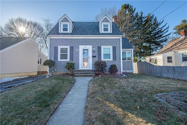 cape cod house with a front lawn