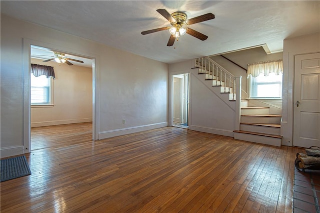 unfurnished living room featuring hardwood / wood-style flooring and ceiling fan