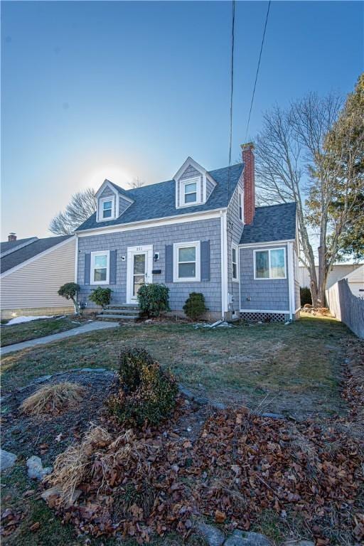 cape cod-style house featuring a front yard