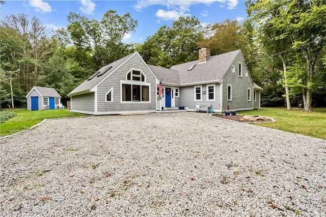 view of front of home with an outbuilding and a front lawn