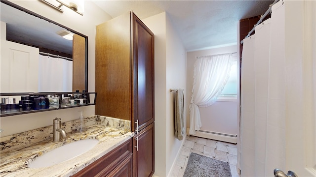 full bath with a baseboard heating unit and vanity