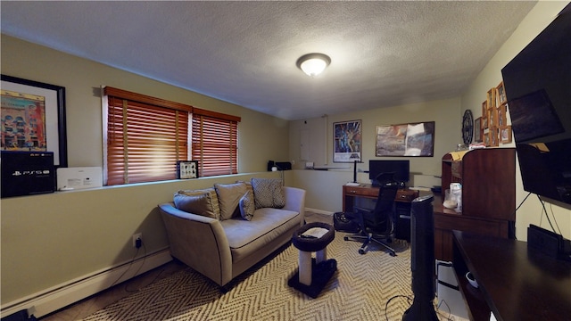 office space featuring a baseboard heating unit and a textured ceiling