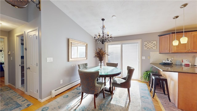 dining room with a baseboard radiator, light wood-style floors, vaulted ceiling, a chandelier, and baseboards