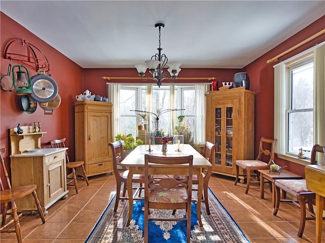 tiled dining space with an inviting chandelier