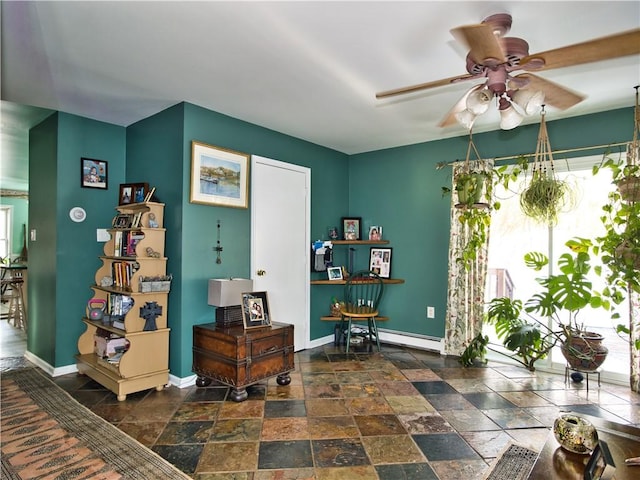 interior space with a baseboard radiator and ceiling fan