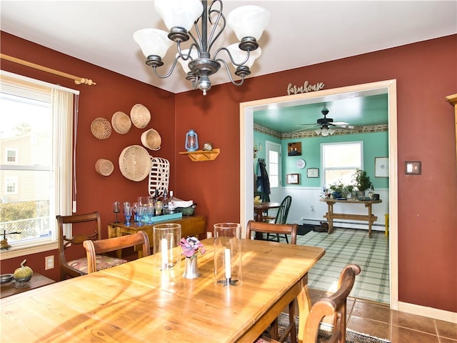 dining area with a baseboard radiator, ceiling fan with notable chandelier, and a wealth of natural light