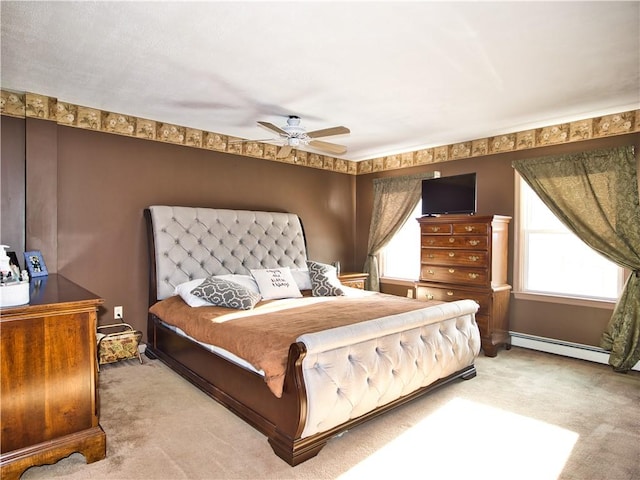 bedroom with light carpet, a baseboard radiator, and ceiling fan