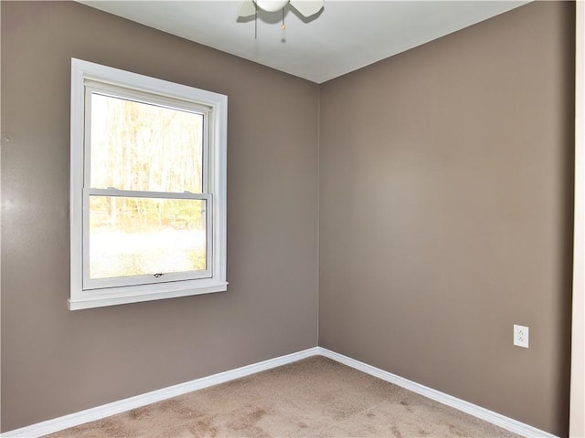 empty room featuring light carpet and ceiling fan