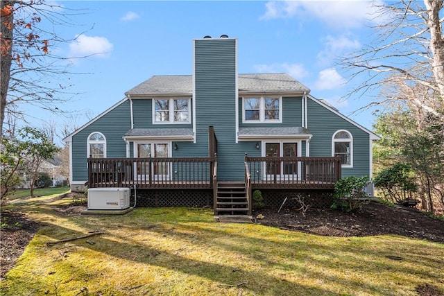 back of house featuring a yard and a deck