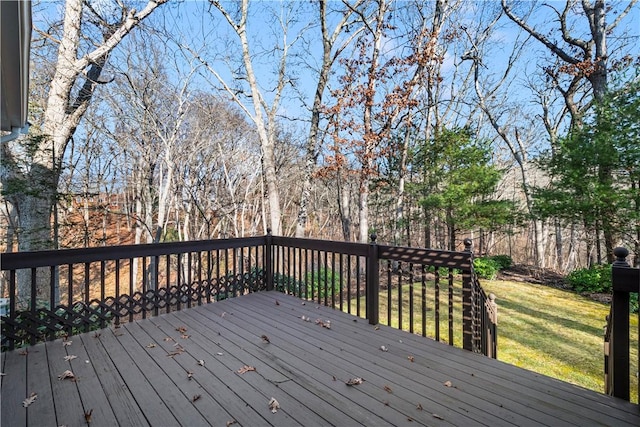 wooden deck featuring a yard