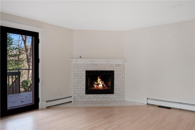 unfurnished living room featuring a baseboard radiator, a fireplace, and light hardwood / wood-style flooring