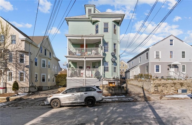 view of front of property with a balcony and covered porch