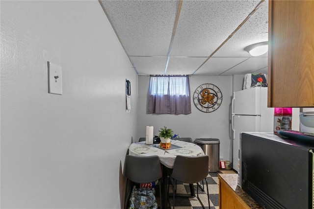 dining area with a drop ceiling