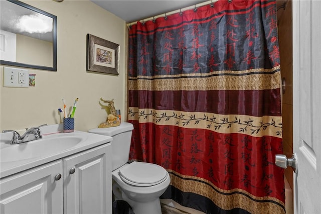 bathroom featuring vanity, toilet, and a shower with shower curtain