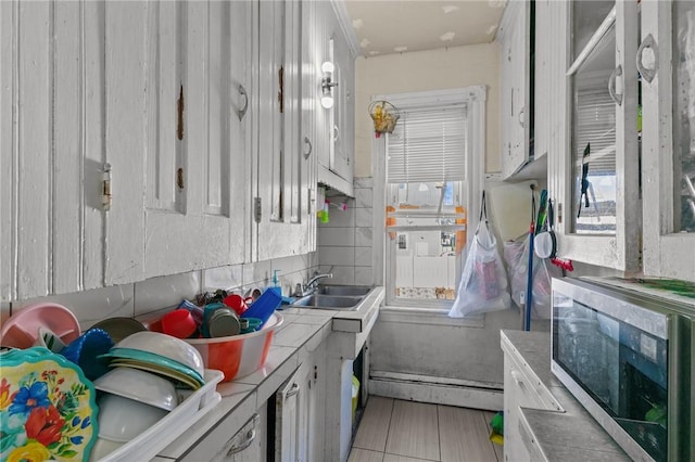 kitchen featuring white cabinetry and sink