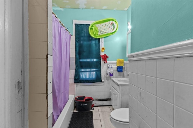 full bathroom with tile patterned flooring, tile walls, vanity, toilet, and shower / bath combo with shower curtain