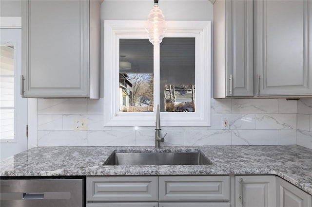 kitchen with sink, gray cabinets, dishwasher, hanging light fixtures, and tasteful backsplash