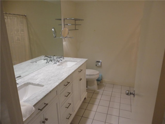 bathroom with vanity, tile patterned floors, and toilet