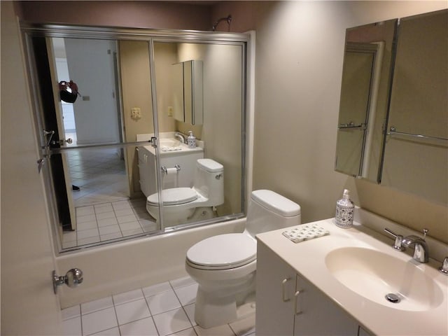 full bathroom with toilet, tile patterned floors, vanity, and bath / shower combo with glass door