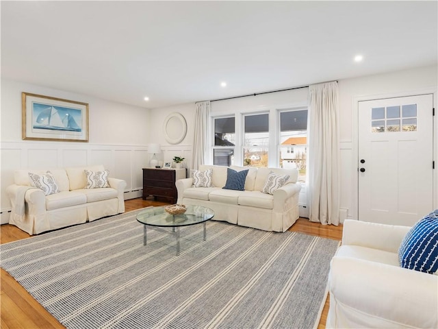 living room with light hardwood / wood-style flooring and baseboard heating