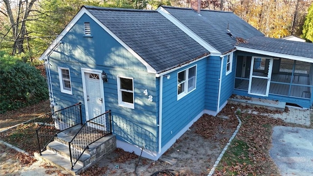 back of house featuring a sunroom