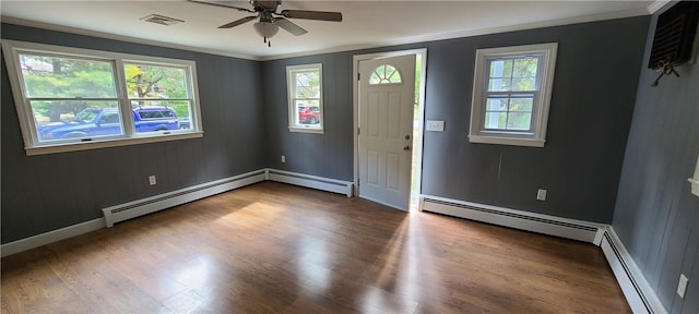 foyer entrance featuring a baseboard radiator, wood-type flooring, ceiling fan, and crown molding