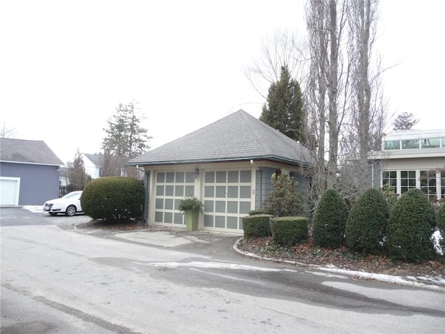 view of side of property featuring a garage and an outdoor structure