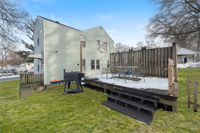 back of house featuring a wooden deck and a yard