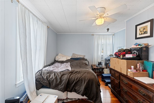 bedroom with crown molding, ceiling fan, and light hardwood / wood-style floors