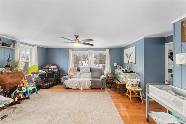 interior space with wood-type flooring, ceiling fan, and crown molding