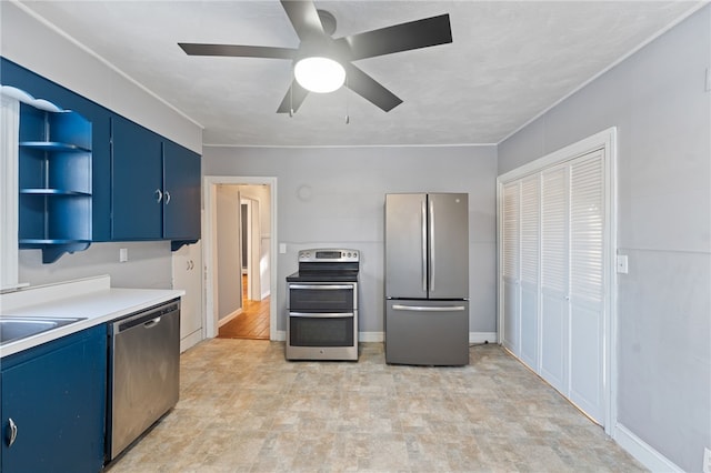 kitchen with blue cabinets, appliances with stainless steel finishes, sink, and ceiling fan