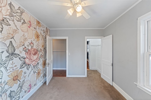 unfurnished bedroom featuring crown molding, light colored carpet, and ceiling fan