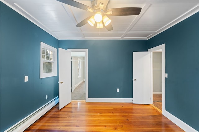 unfurnished bedroom featuring ceiling fan, wood-type flooring, and a baseboard heating unit