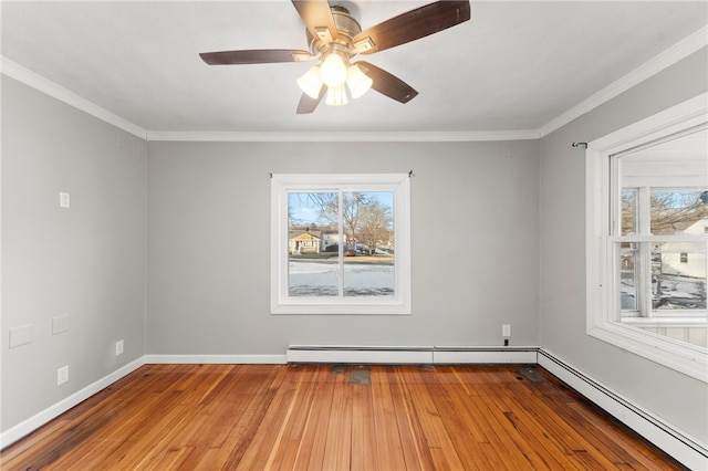 empty room with wood-type flooring, ornamental molding, a healthy amount of sunlight, and baseboard heating