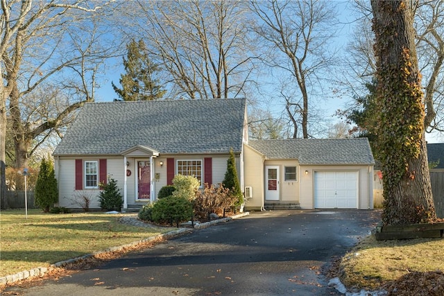 view of front of property with a garage and a front yard